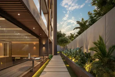 Level Pratumnak outdoor swimming pool with waterfall feature, in-pool sun loungers and lush tropical landscaping