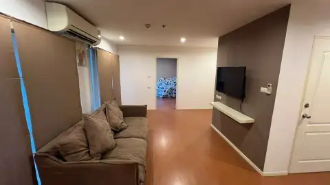 2 Bedroom Condo for Sale at Lumpini Condo Town North Pattaya-Sukhumvit living room with wall-mounted TV and brown sofa