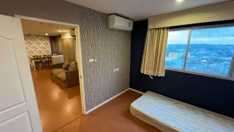 2 Bedroom Condo for Sale at Lumpini Condo Town North Pattaya-Sukhumvit bedroom with city view window and patterned accent wall