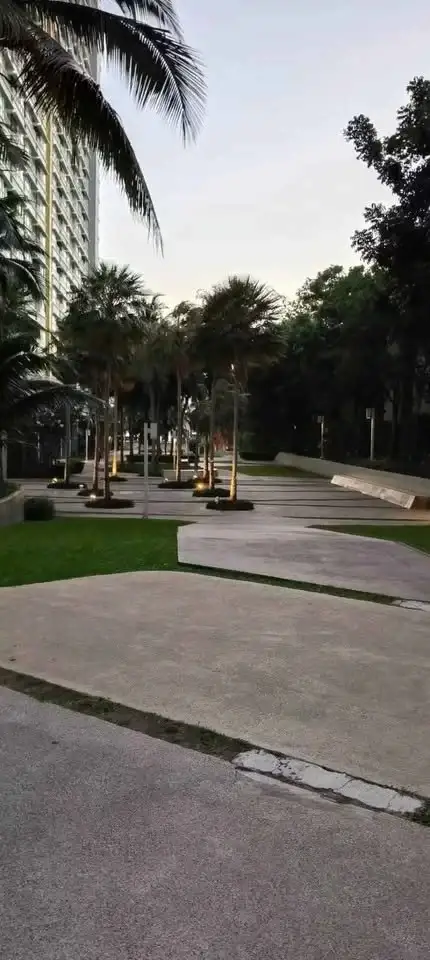 2 Bedroom Condo for Sale at Lumpini Park Beach Jomtien palm tree lined pathway through condo grounds