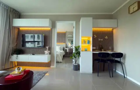 1 Bedroom Condo for Sale at Lumpini Ville Naklua-Wongamat open-plan living area with TV console, dining nook and bedroom view
