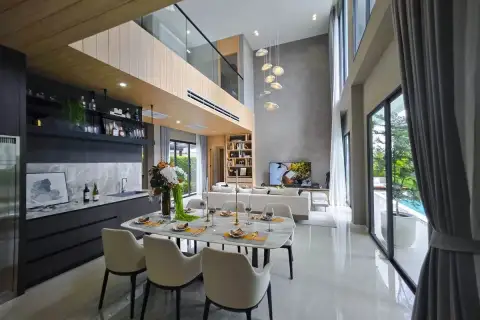 4 Bedroom House for Sale at Luxury Vista Villas open-plan dining and living area with marble table, dark kitchen, and pool view