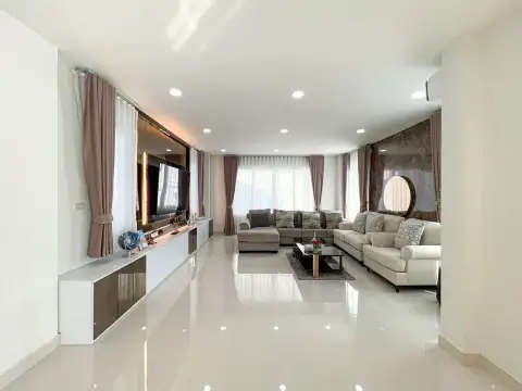 4 Bedroom House for Sale & Rent in Mabprachan spacious living area with sectional sofas and round mirror accent