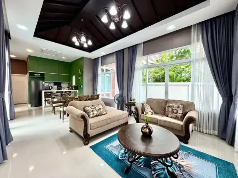 2 Bedroom House for Rent in Mabprachan open-plan living room with green kitchen cabinets and wood ceiling
