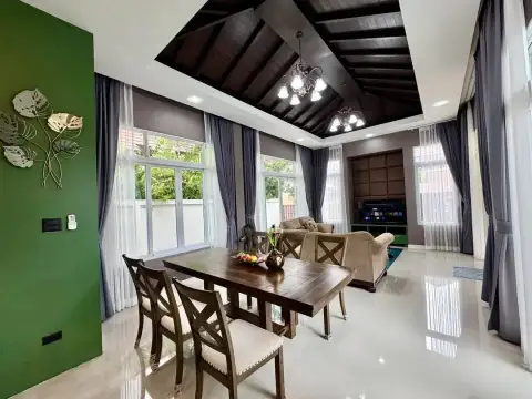 2 Bedroom House for Rent in Mabprachan dining room with wooden table, TV area and vaulted wood ceiling