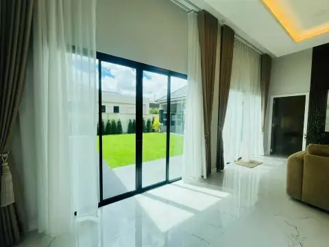 3 Bedroom House for Sale in Mabprachan living room sliding glass doors overlooking green garden