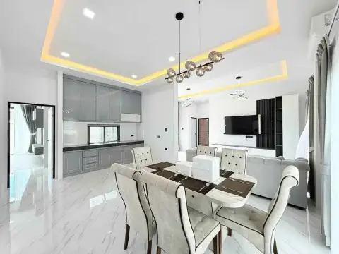 3 Bedroom House for Rent in Mabprachan dining table set for six beside open kitchen and lounge area