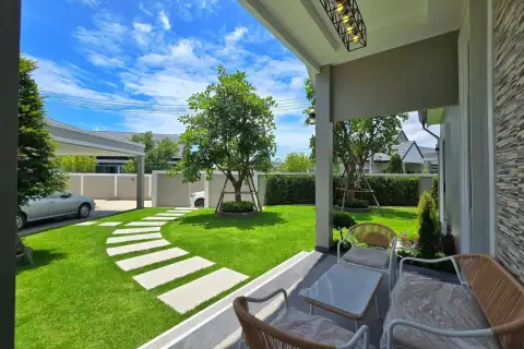 4 Bedroom House for Sale in Mabprachan covered porch with outdoor seating overlooking driveway and garden