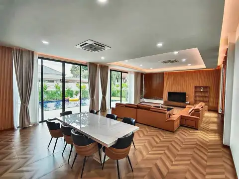 5 Bedroom House for Rent in Mabprachan dining and living area with marble table and wood accent wall