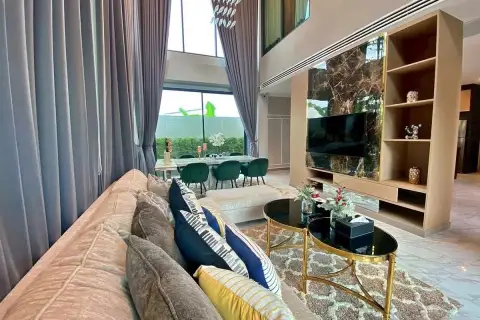 4 Bedroom House for Sale & Rent at Madcha Nirvana bright living room with plush sofa and marble-panel TV wall