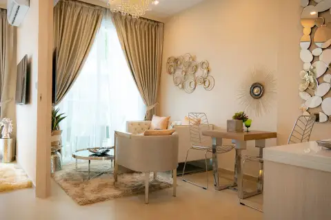 1 Bedroom Condo for Sale at Marina Golden Bay open-plan lounge and dining space with plush sofa and mirrored wall