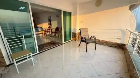 Studio Condo for Sale at Metro Jomtien Condotel tiled balcony with chairs and sea view