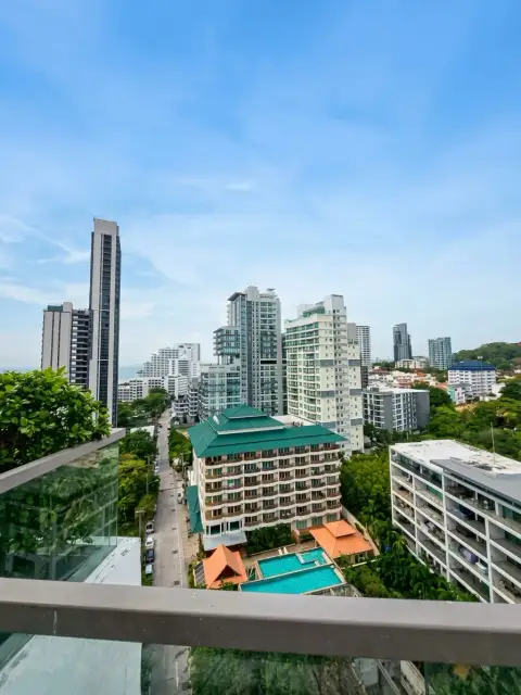 1 Bedroom Condo for Sale at The Peak Towers balcony view overlooking Pattaya city skyline and pool
