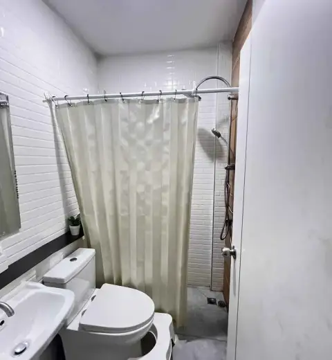 2 Bedroom Townhouse for Rent in Na Kluea bathroom with toilet, sink and curtained shower area
