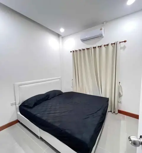 2 Bedroom Townhouse for Rent in Na Kluea master bedroom with black bedding, white headboard and air conditioning unit