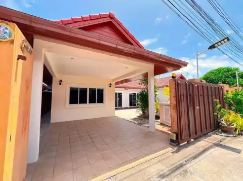 3 Bedroom House for Rent in Na Kluea covered carport entrance with red tiled roof and wooden gate
