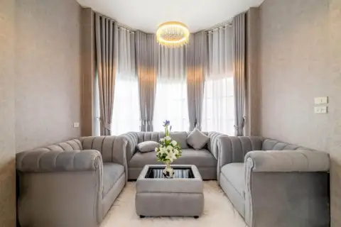 3 Bedroom House for Sale in Nong Pla Lai cozy seating nook with curtained windows and crystal chandelier