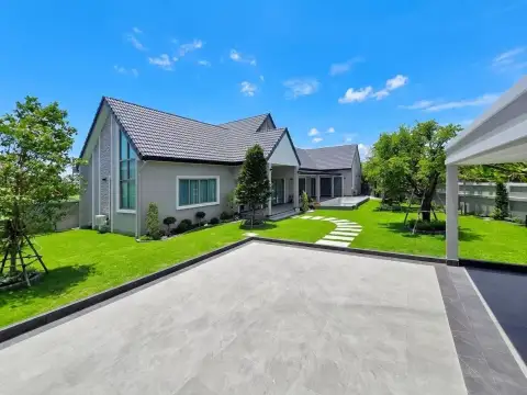 4 Bedroom House for Sale in Nong Prue exterior view with driveway, carport, and manicured lawn