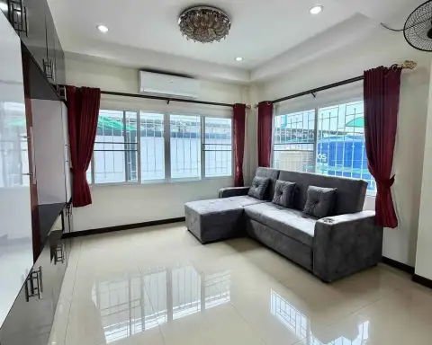 3 Bedroom House for Rent in Nong Prue living room with gray sectional sofa and chandelier