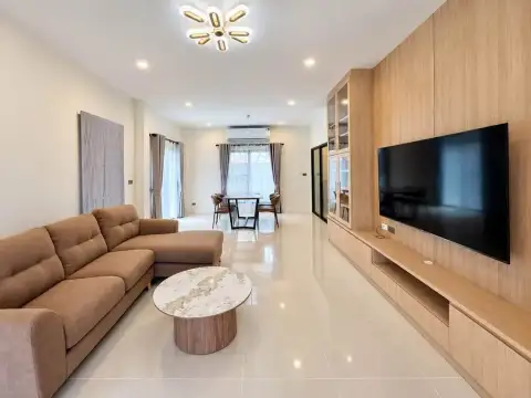 3 Bedroom House for Rent in Nong Prue open-plan living room with sectional sofa and wall-mounted TV
