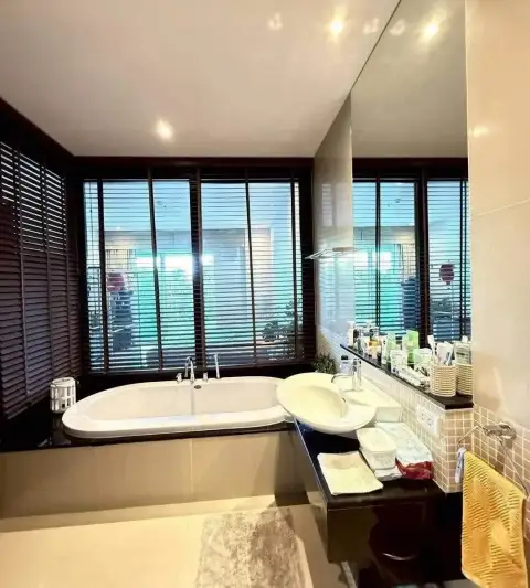 1 Bedroom Condo for Sale at Ocean Portofino bathroom with soaking tub and wooden window blinds