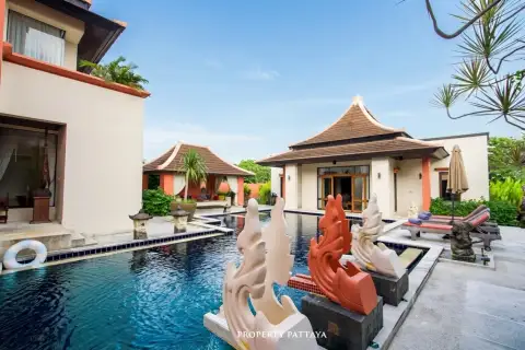 Phutara outdoor swimming pool with decorative statues, surrounded by traditional Thai-style buildings.