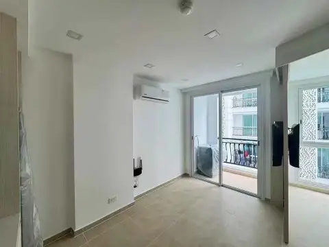 1 Bedroom Condo for Sale at Olympus City Garden living area with sliding glass door to balcony