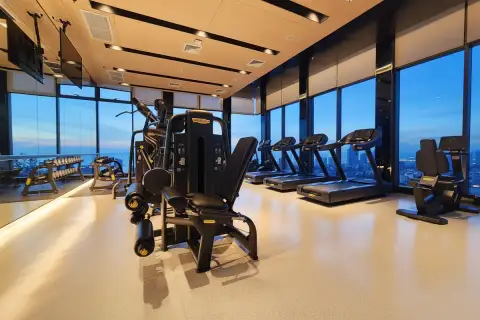 Once Pattaya modern fitness center with treadmills and weight machines, offering panoramic city views.