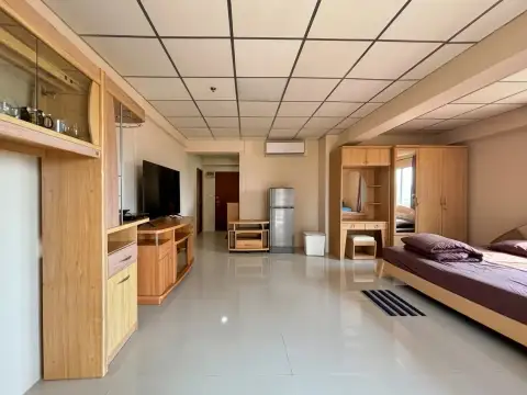 2 Bedroom Condo for Sale at Jomtien Beach Condominium hallway view with wardrobe, fridge, TV, and vanity desk