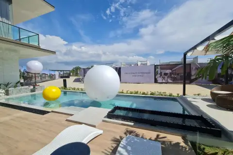 Highbury Hill Pool Villas Pattaya private pool with timber deck and sun loungers under open blue sky