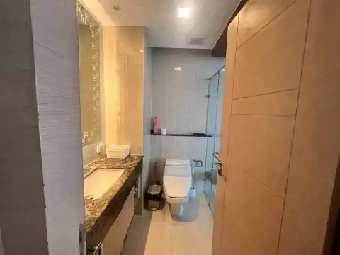 1 Bedroom Condo for Sale at Palm Wongamat bathroom with marble vanity and glass shower