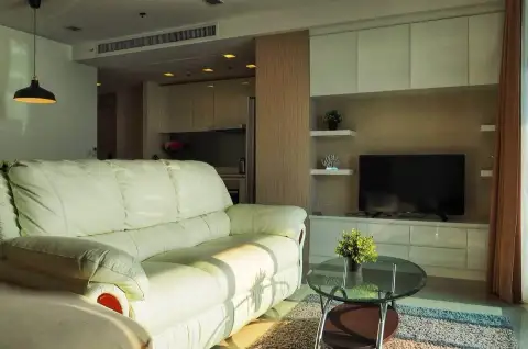 2 Bedroom Condo for Rent at Palm Wongamat living room with cream leather sofa and wall-mounted TV
