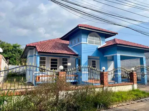 2 Bedroom House for Sale at Park Village blue exterior facade with red tile roof and gated entrance