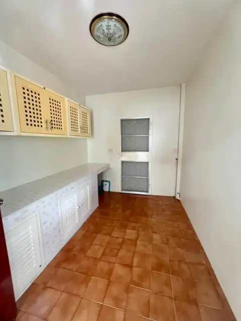 2 Bedroom House for Sale at Park Village kitchen area with built-in cabinets and terracotta tile flooring