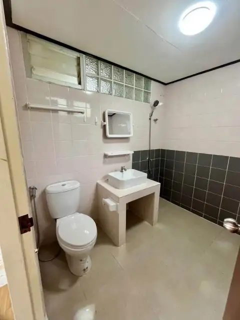 2 Bedroom House for Sale at Park Village bathroom with toilet, sink vanity, and tiled shower wall