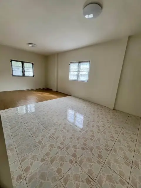 2 Bedroom House for Sale at Park Village open space with tiled and wood flooring and barred windows
