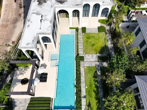 4 Bedroom House for Sale at Patta Arcade aerial view of lap pool, patio lounge area and landscaped garden