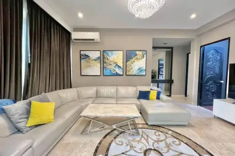 4 Bedroom House for Sale at Mountain Village 1 spacious living room with beige sectional sofa and framed artwork