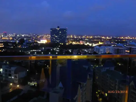 1 Bedroom Condo for Sale at Grande Caribbean night view of Pattaya city skyline from balcony
