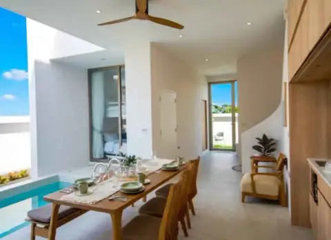 3 Bedroom House for Rent in Central Pattaya dining table set beside pool with staircase and hallway