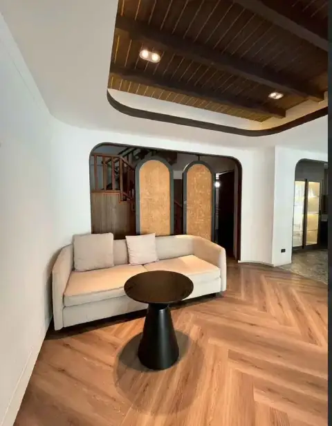 4 Bedroom House for Rent in Central Pattaya living room with wooden plank ceiling, beige sofa, and herringbone floor