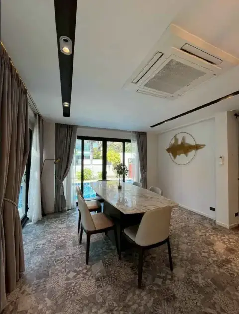 4 Bedroom House for Rent in Central Pattaya dining room with marble table, patterned tile floor, and pool view