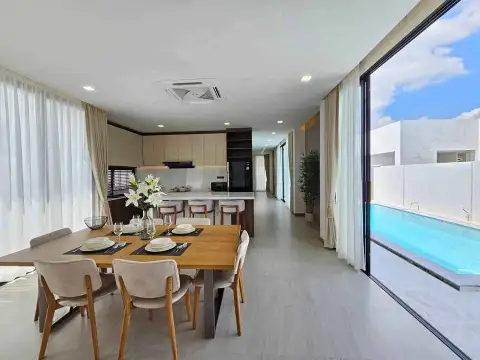 3 Bedroom House for Sale in Pong open-plan dining and kitchen area with pool view through glass doors