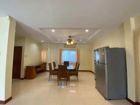 3 Bedroom House for Sale in Pattaya - open dining area with wooden table and stainless steel fridge