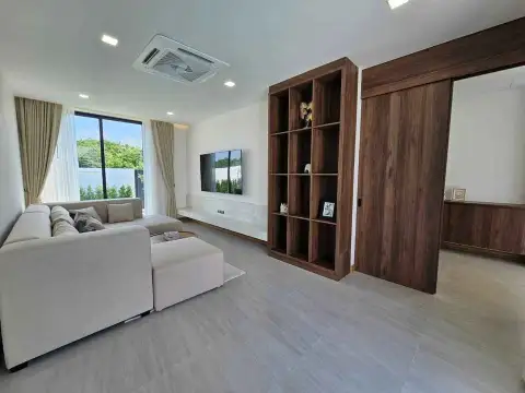 3 Bedroom House for Sale in Pong living room with sectional sofa, TV and wooden shelving