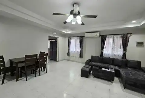 3 Bedroom House for Rent at Pattaya Lagoon Village living and dining space with ceiling fan and curtained windows
