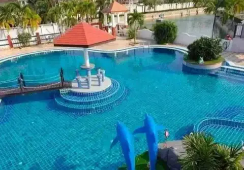 3 Bedroom House for Rent at Pattaya Lagoon Village community swimming pool with dolphin statues and lagoon view