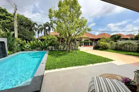 Pattaya paradise village 1 backyard pool deck with garden and neighborhood view