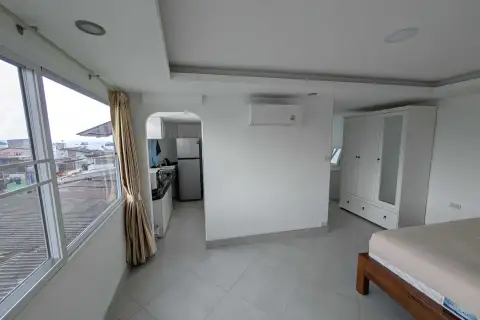 1 Bedroom Condo for Rent at Pattaya Beach Condo bedroom view toward kitchenette and wardrobe with city window view