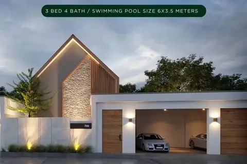 Baan Mae Pool Villa modern exterior with a distinctive roofline, stone facade, and a two-car garage.